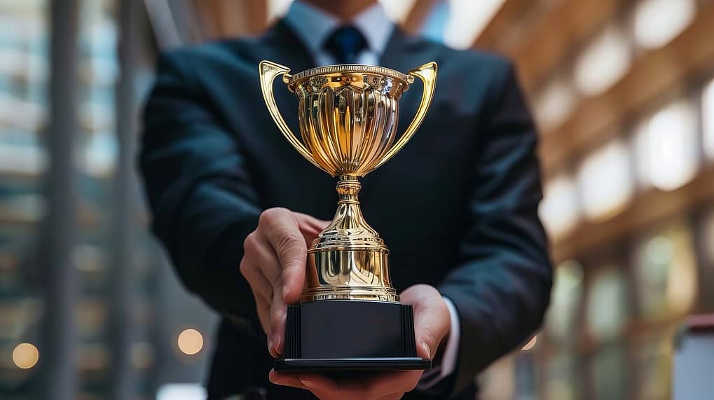 man showing a trophy, indicating success