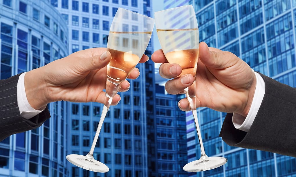 two businessmen sharing champagne, a metaphor for buying a business