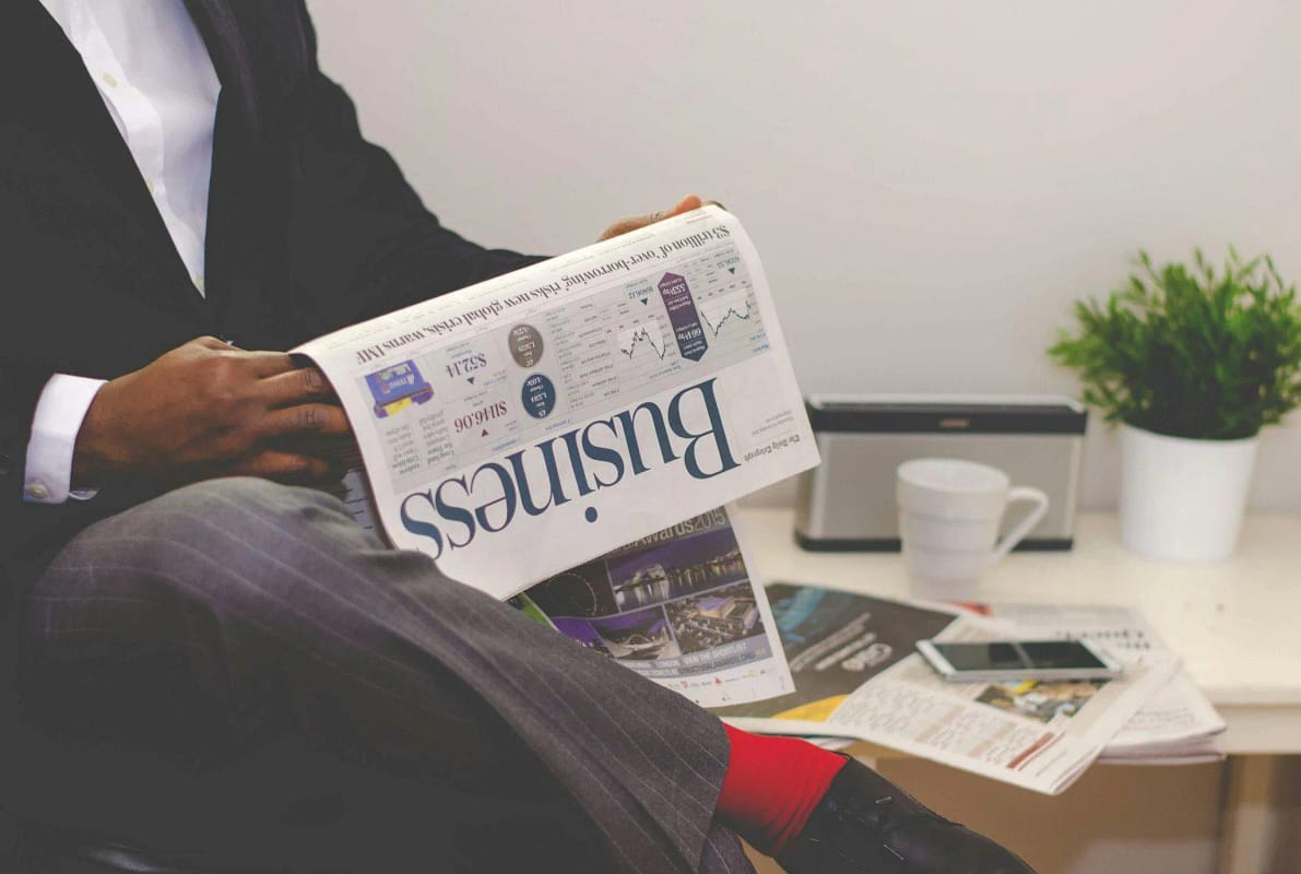 a businessman reading a paper on business-related news