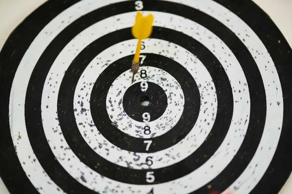 a dartboard with a dart near the center, artistically representing success