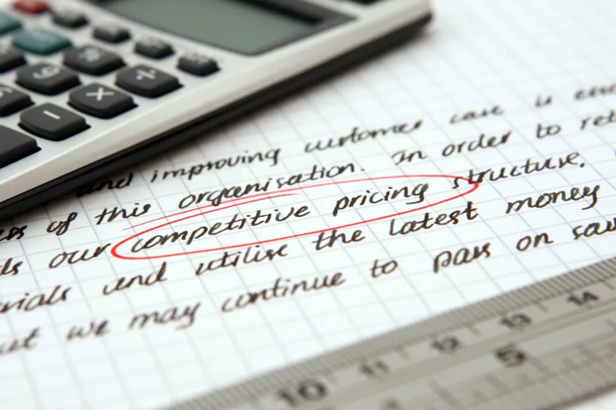 calculator and written text with the word "competitive pricing" circled in red