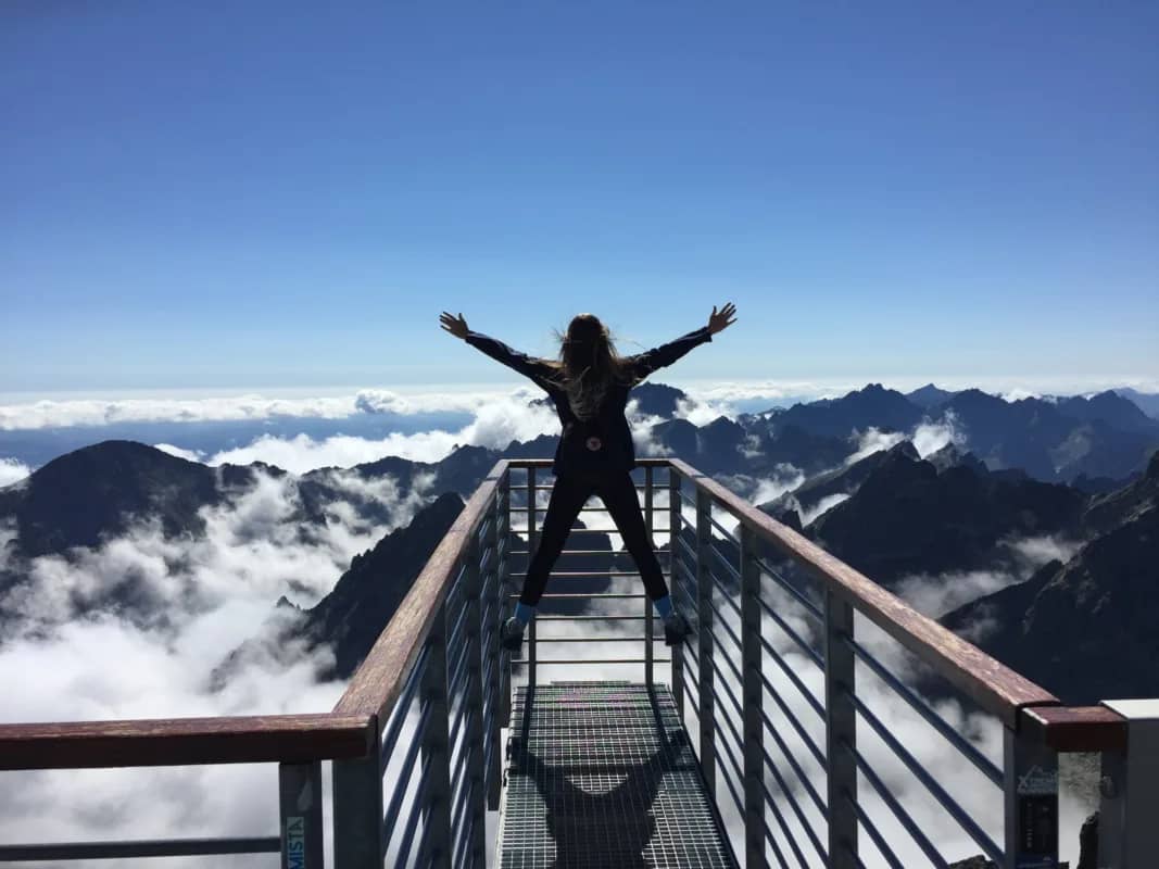 a sihouette of a woman with her arms raised in victory signifying success through personal development