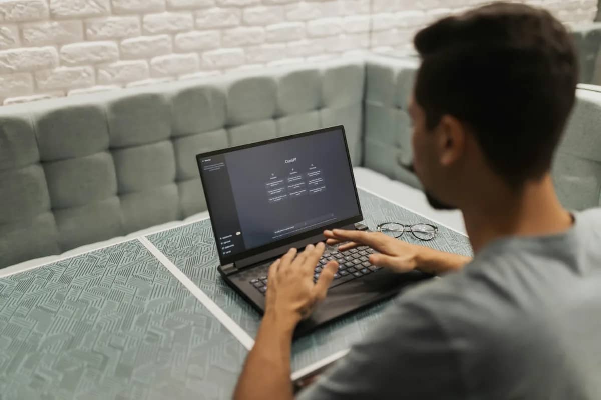 a person on a laptop while using chatgpt, one of the the many ways ai can be used by business leaders