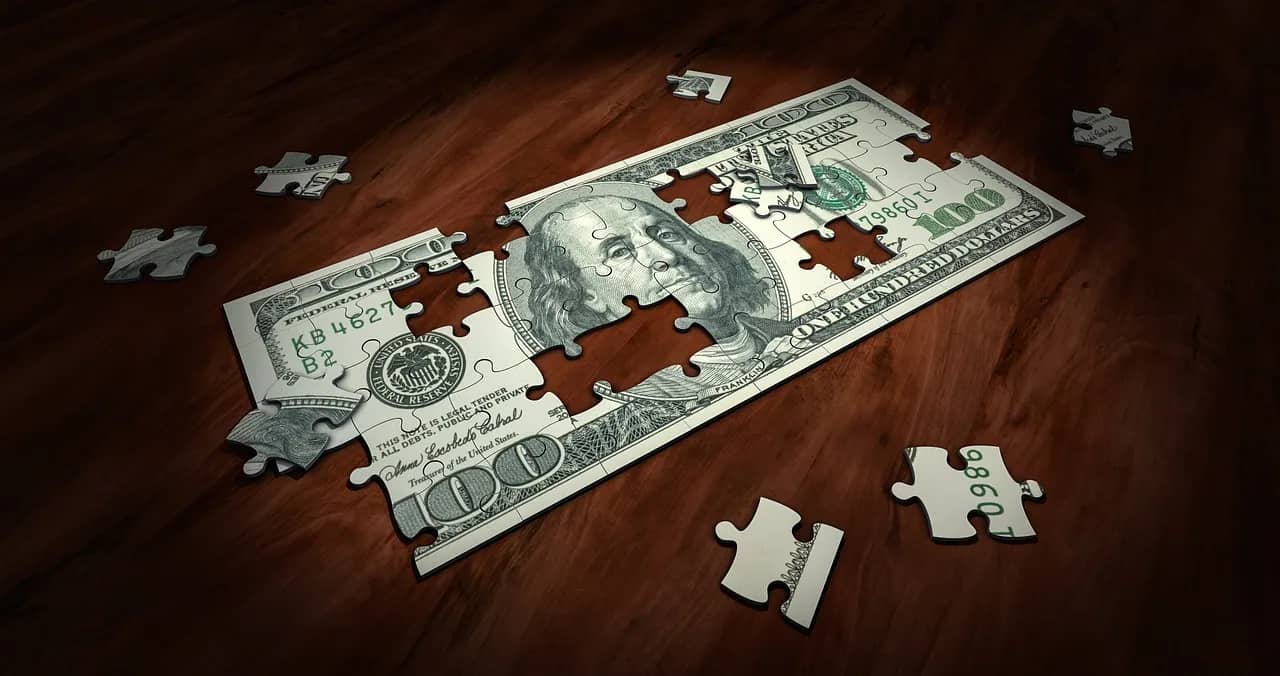 a jigsaw puzzle of a dollar bill, signifying the difficulties of cash flow management