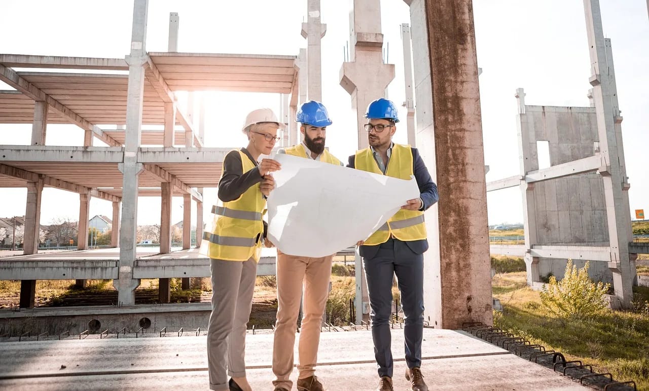 image of engineers going over a building plan, alluding to corporate restructuring