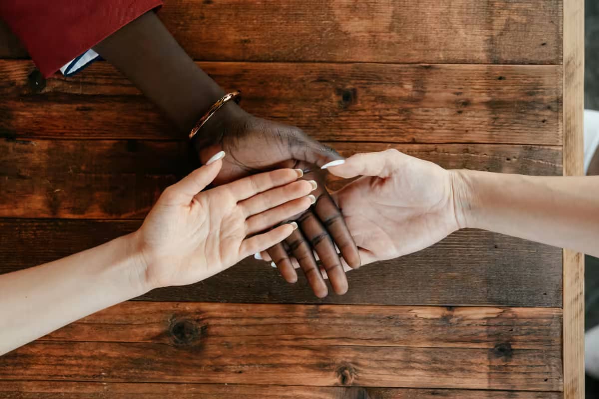3 hands join together, symbolizing crowdsourcing innovation
