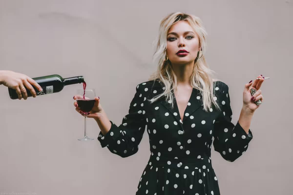 woman smoking and drinking, showcasing bad habits