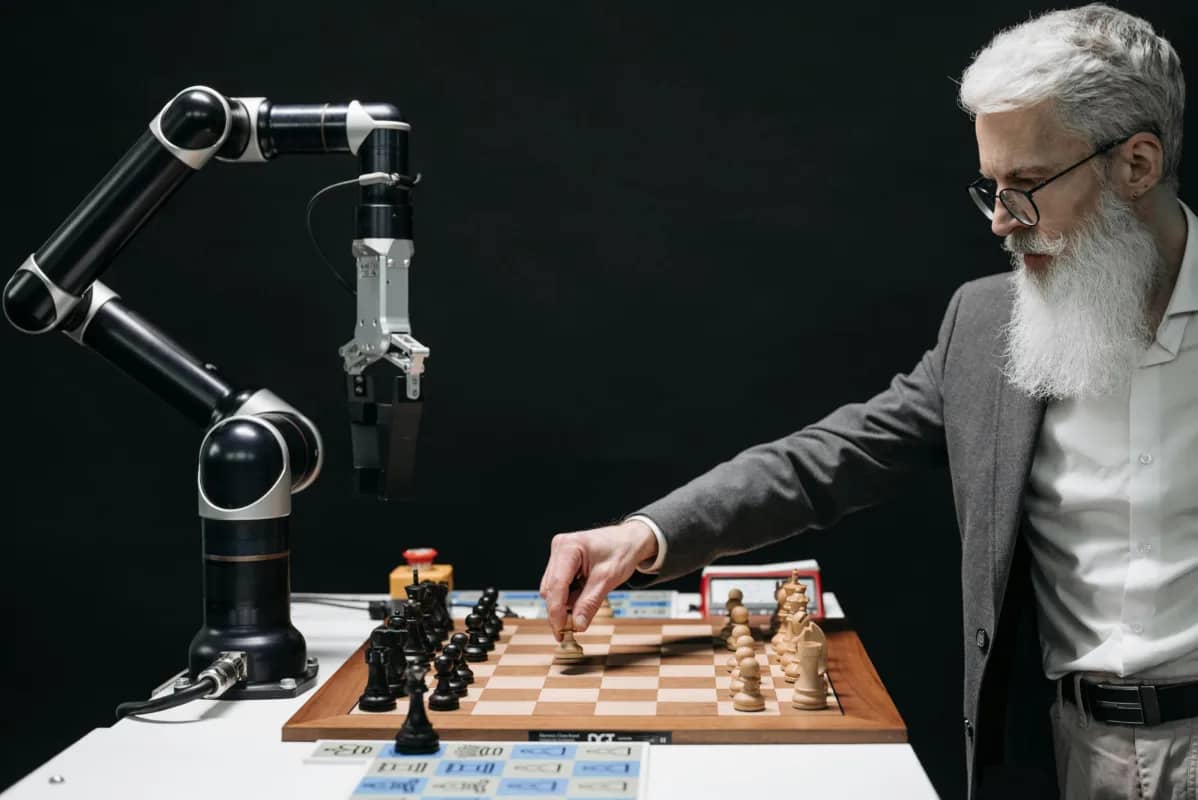 a man playing chess with an ai-powered robot