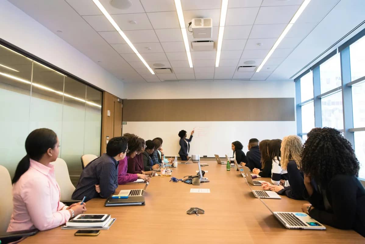 a whole meeting room paying close attention to the person presenting