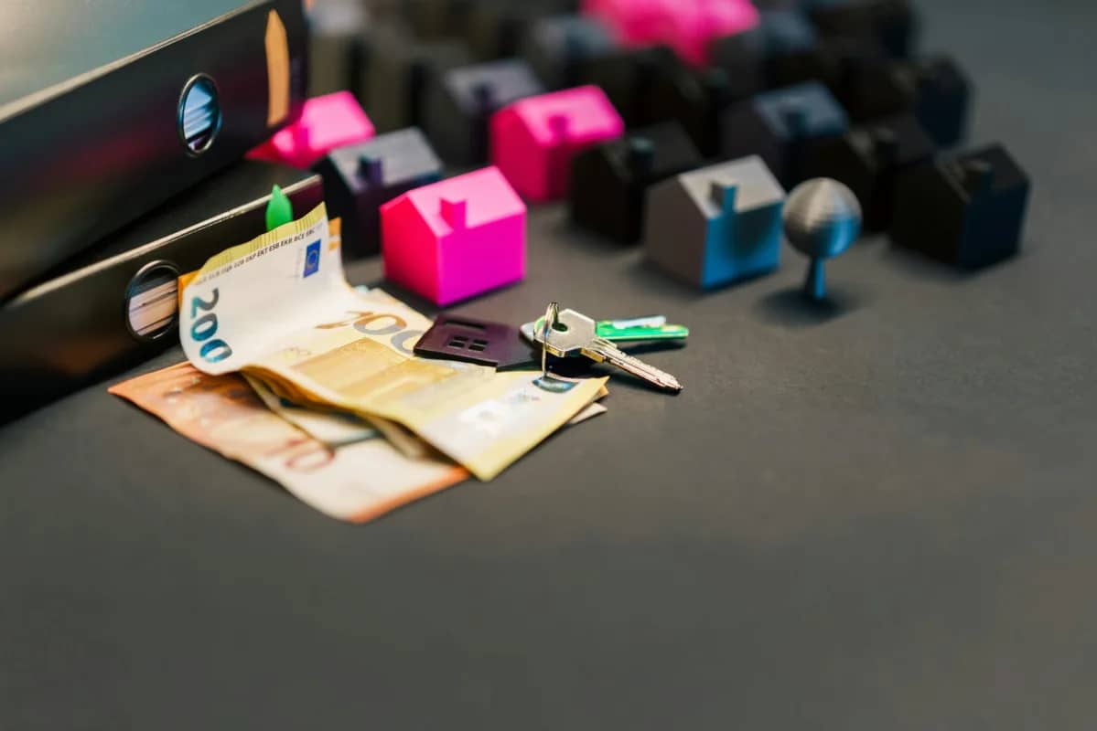 image with keys, money, and property miniatures. Things associated with business exit planning