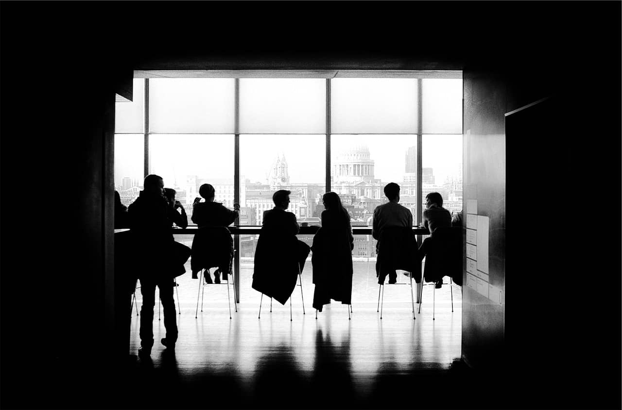 silhouette of management making decisions in a meeting