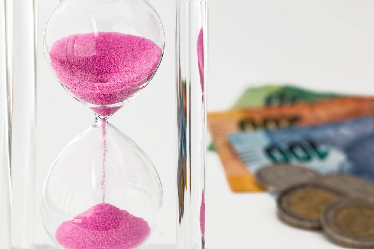 image of an hourglass next to some money, figuratively signifying the importance of future-proofing your business