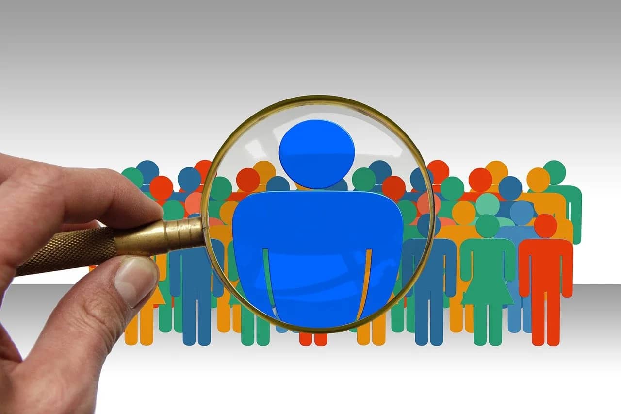 a magnifying glass singling out an individual with the qualities of a good leader