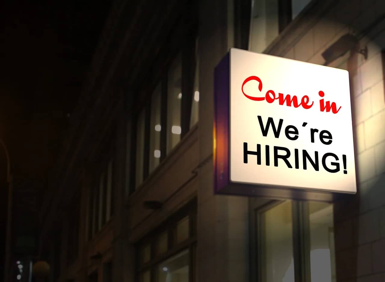 a sign that says "come in we're hiring"